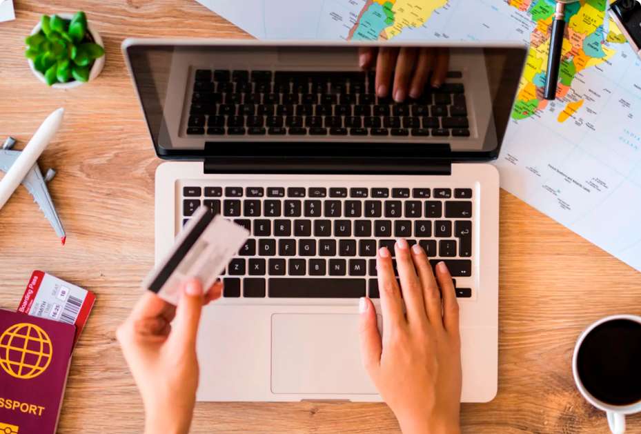 Pessoa organizando roteiro turístico no notebook utilizando consórcio viagem